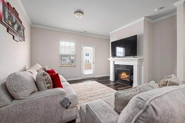 grey couch in front of a fireplace