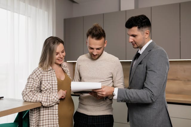 three people looking at documents