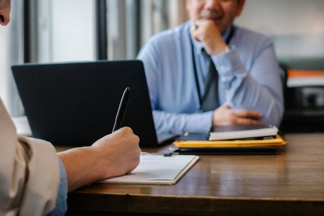two people sitting across a table from eachother