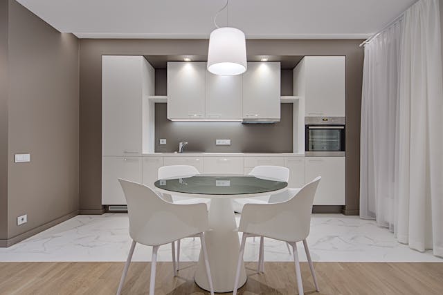 kitchen-with-grey-brown-walls-white-cupboards-and-kitchen-table